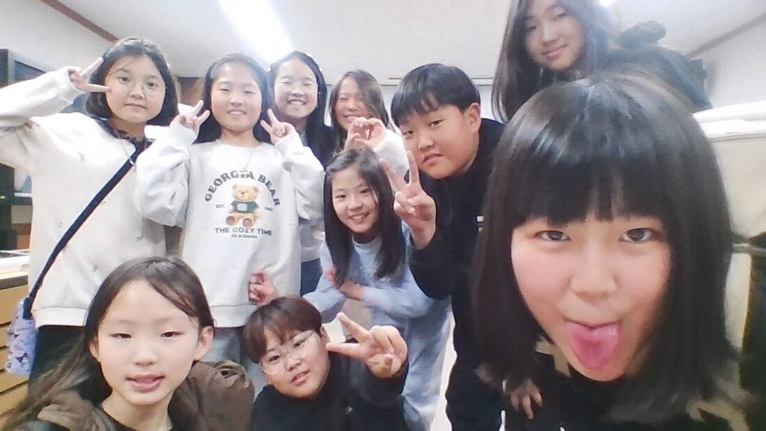 Group photo with students making peace signs