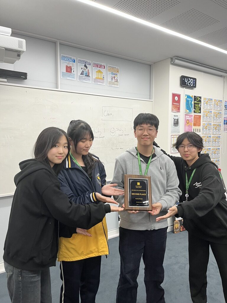 Team holding the second-place plaque after the IHBB Korea Varsity Division