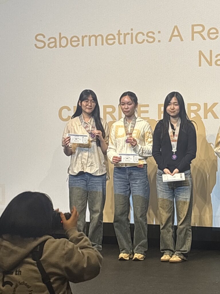 Holding second-place medals on stage at National History Day Korea